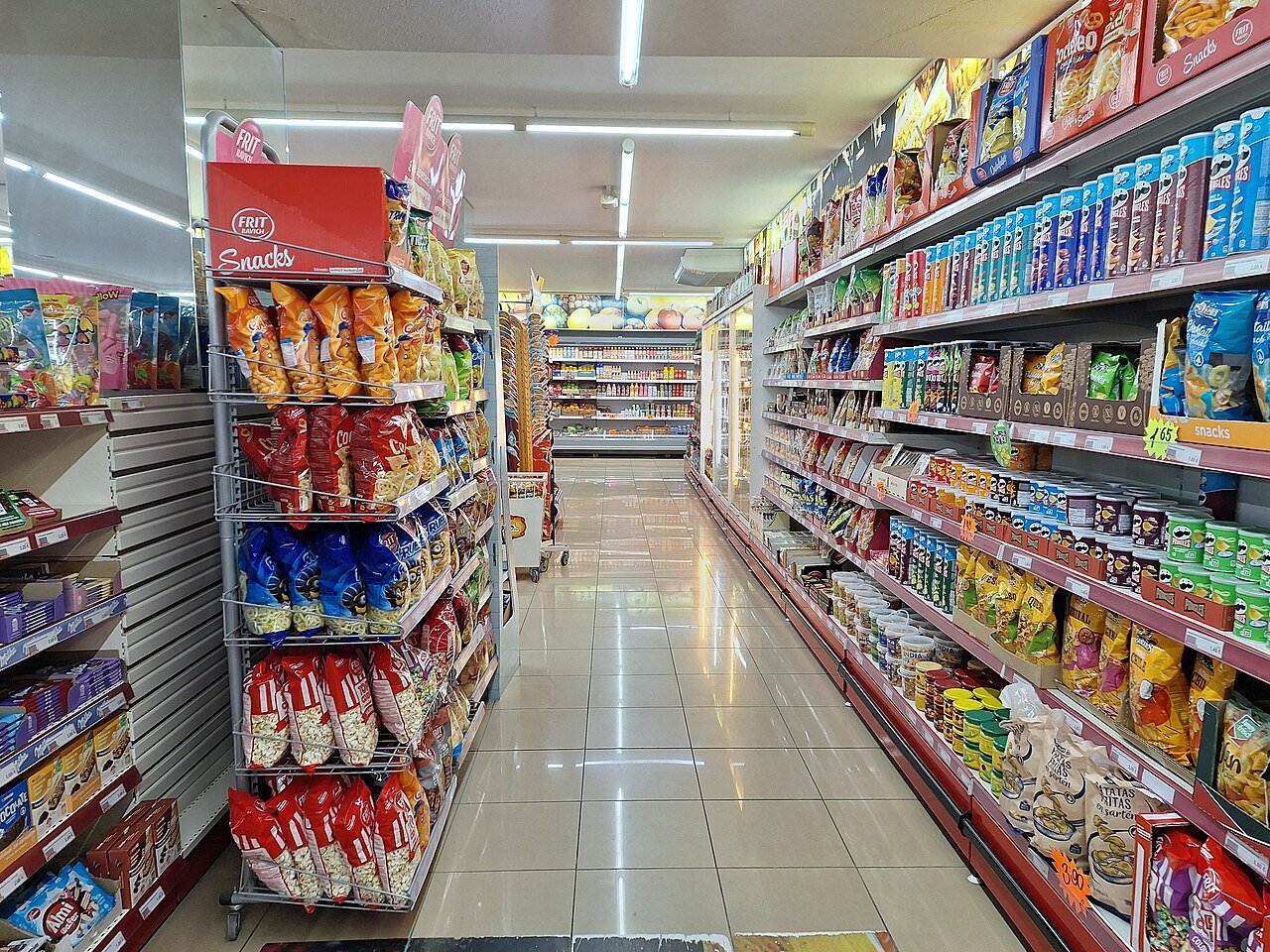 Supermarket aisle with refrigerated display cases along the side
